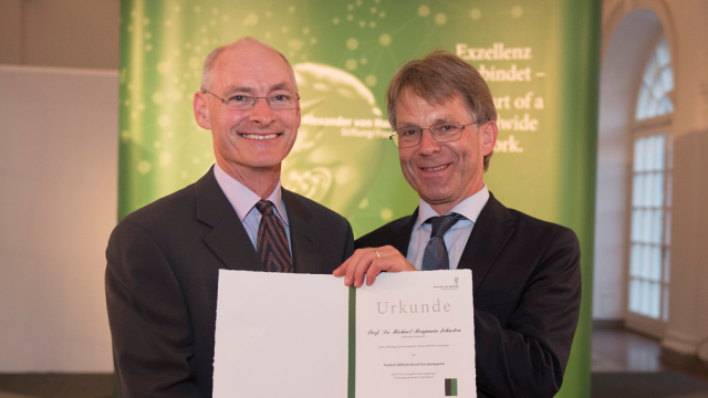 Prof Johnston (left) being awarded the Friedrich Wilhelm Bessel Research Award at Schloss Charlottenburg by the President of the Alexander von Humboldt Foundation, Professor Dr Hans-Christian Pape (right). © Humboldt-Stiftung/Jens Jeske